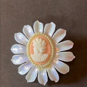 Vintage cameo pin with iridescent petals.